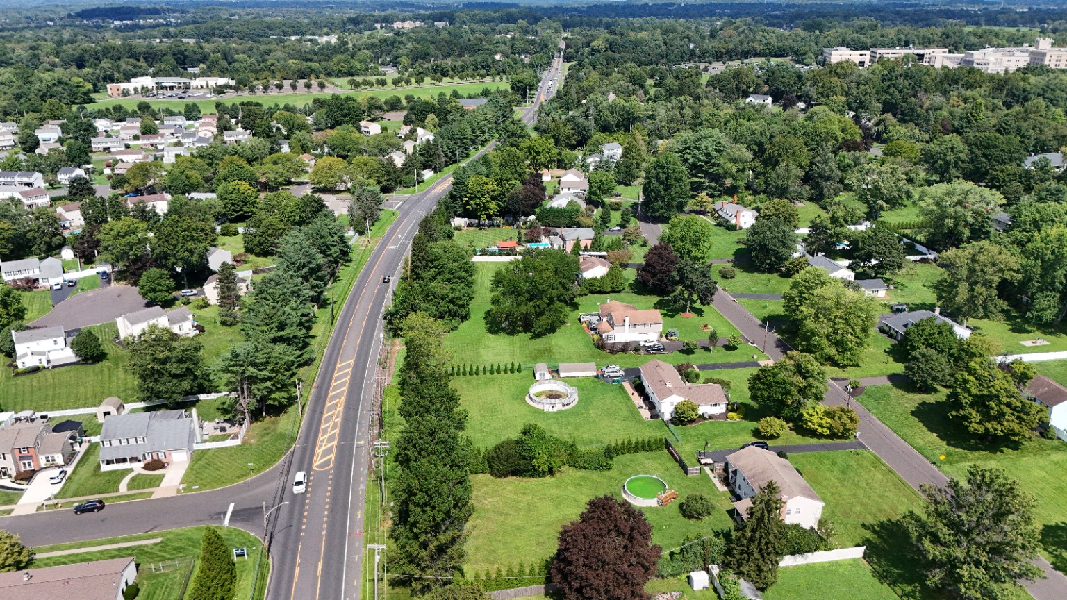 Aerial view along a main road through a residential neighborhood