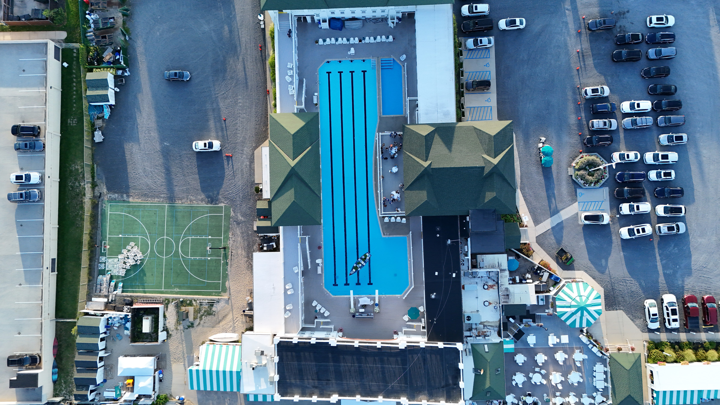 Overhead view of the turquoise pool, floral canoe, and venue at Monmouth Beach Bath & Tennis Club.