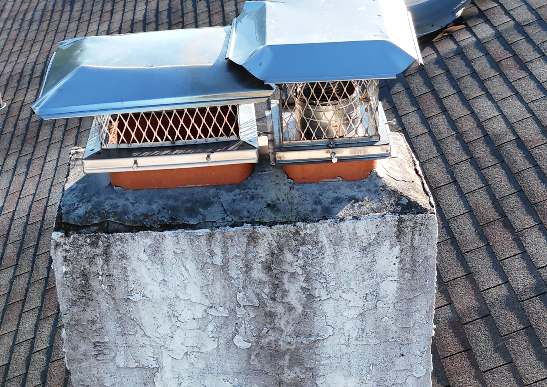 Closer aerial photograph of the chimney exterior and cap